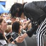 Matthew N. Wells / The Daily World
13-year-old rock photographer Jameson Nebel, left, shakes the impressive right hand of Kathy Moore. Moore, a guitarist for The Bona Fide Band featuring Krist Novoselic. While Moore shredded on stage with her complex and powerful leads, Nebel shot from the crowd the important moments of the set. So happy after the exchange with Moore, Nebel, of Hoquiam, ran up to her mom Kimmy and hugged her. The connection seen here is the point of World Music Day, to get everyone involved in music and to have fun.