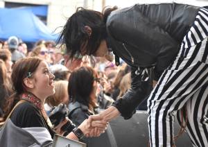 Matthew N. Wells / The Daily World
13-year-old rock photographer Jameson Nebel, left, shakes the impressive right hand of Kathy Moore. Moore, a guitarist for The Bona Fide Band featuring Krist Novoselic. While Moore shredded on stage with her complex and powerful leads, Nebel shot from the crowd the important moments of the set. So happy after the exchange with Moore, Nebel, of Hoquiam, ran up to her mom Kimmy and hugged her. The connection seen here is the point of World Music Day, to get everyone involved in music and to have fun.