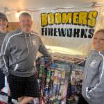 Matthew N. Wells / The Daily World
Three quarters of the Gleason family  Parker with his parents Damon and Gina  stand for a photo at Boomers Fireworks. Pierce, Damons and Ginas daughter, also works at the business but wasnt at the tent Tuesday morning. The Gleasons have run the business in the white tent that sits across from Billys Bar and Grill on Heron Street since a well-timed vacation to Harden, Montana. Damon and Gina, with then-infant son Parker, met Matt Elbue, who wowed them with a firework display and soon turned it into a recruitment trip as he got them interested in running their own fireworks business. 20 years later, Boomers Fireworks is going strong and Damon loves working it with his family.