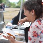 Capturing a woman smiling as she serves a corn dog to a hungry Splash Festival attendee. (Rick Moyer of Moyer Multi Media LLC.)