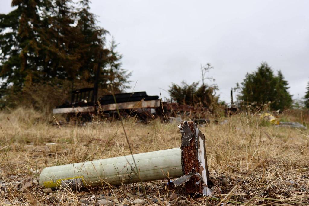 Michael S. Lockett / The Daily World
A discarded mortar tube lies in front of the charred remains of a destroyed trailer in Elma.