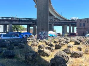 Matthew N. Wells / The Daily World
On a scorcher of a day  the National Weather Service set a heat advisory Monday through Tuesday at 11 a.m.,  people at the homeless encampment just off State Street were seen covering their heads from the hot sun.