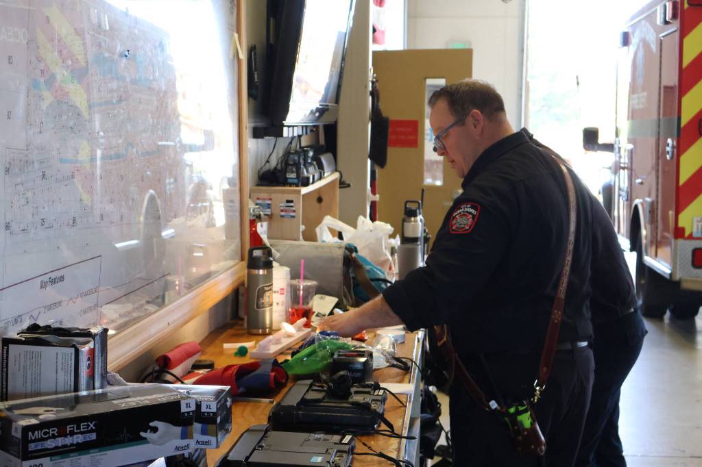 Michael S. Lockett / The Daily World
Ocean Shores Fire Chief Brian Ritter readies gear before stepping off on the Fourth of July.