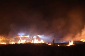 A dune grass fire lights up the sky on the Fourth of July. (Michael S. Lockett / The Daily World)