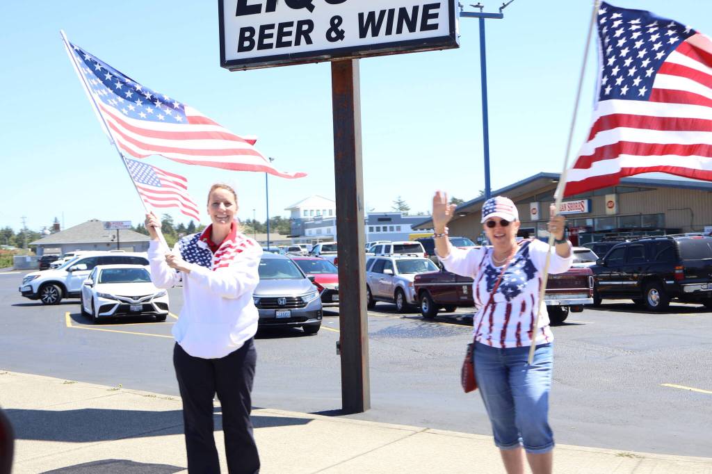 Michael S. Lockett / The Daily World
Ocean Shores residents waves at passing firefighters on the Fourth of July.