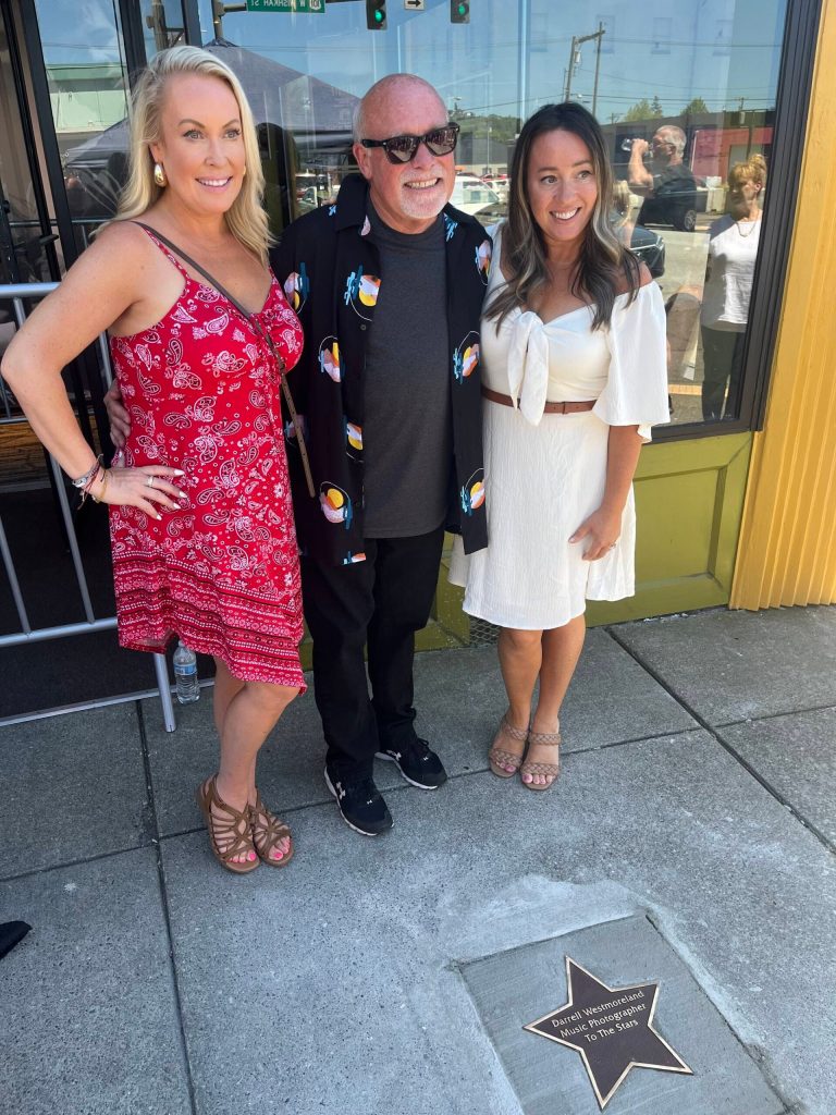 Matthew N. Wells / The Daily World
Darrell Westmoreland stands proudly with his daughters, Darnell Sue-Lindahl, left, and Corrie Westmoreland-Vairo, after he unveiled his star to his family and dear friends. Westmoreland, though technically retired, continues to work and people dont think the Music Photographer to the Stars will ever stop doing what he does best.