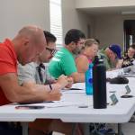 McCleary City Council members read a proposal during a meeting on July 10. (Michael S. Lockett / The Daily World)