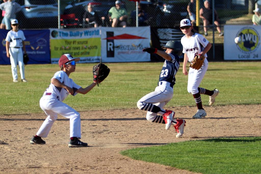 RYAN SPARKS | THE DAILY WORLD Larch Mountains RJ Calica (right) slides in safe ahead of the tag by Montesano shortstop Micah Eaton (left) during Montes 5-3 loss in an 8-10 District 3 championship game on Thursday in Montesano.
