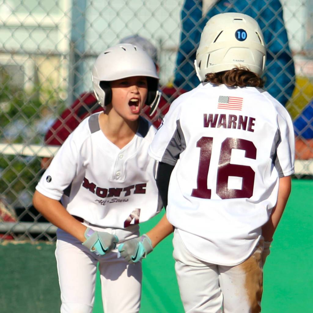 RYAN SPARKS | THE DAILY WORLD Montesanos Max Lalka (left) celebrates with teammate Raider Warne after the two came in to score during an 8-1 win over Larch Mountain in the 9-11 Division District 3 championship game on Friday in Montesano.
