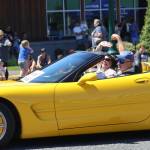 Grand Marshall Carri Comer, in passenger seat, rides in the parade for the McCleary Bear Festival.