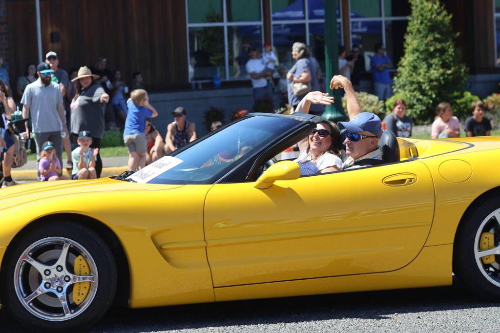 Grand Marshall Carri Comer, in passenger seat, rides in the parade for the McCleary Bear Festival.