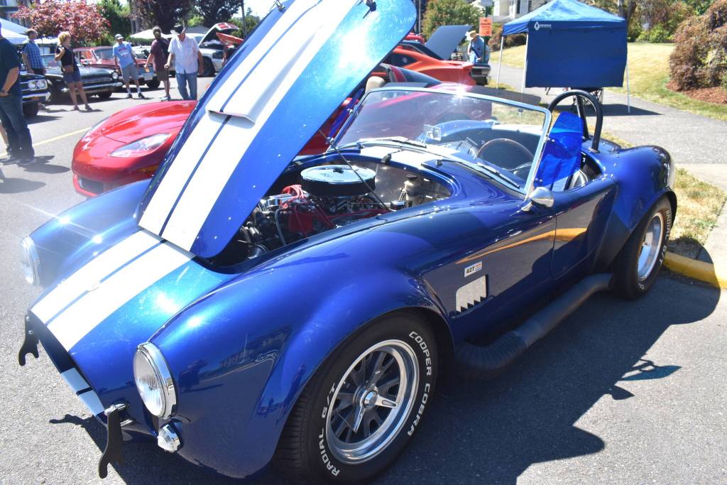 Matthew N. Wells / The Daily World
Tracy Petersons 1966 Shelby Cobra 427 may not have left with an award, but it received a visceral reaction as someone said oh yeah as they approached the race car. Peterson was happy to be several feet from his father, Gerald Peterson, who won the Fire Chief Award for his 1949 Cadillac Convertible.