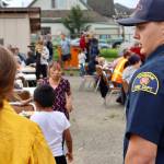 Michael S. Lockett / The Daily World
Firefighters and police take a moment to mingle with residents during a National Night Out event in Hoquiam.