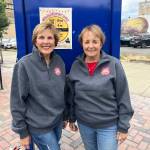 Bette Worth, left, and Bobbi McCracken are excited to bring everyone out to Aberdeen Summerfest on Saturday. The festival itself  stretching along the Broadway Street blocks between Market and Heron streets, goes from 10 a.m., but there is the Show and Shine Car Show that starts at 9:30 a.m. The duo, the rest of the Downtown Aberdeen Association, as well as the sponsors, work hard for this to succeed. Information can be found on all social media channels, local media, and flyers around town such as the one behind them. (Matthew N. Wells / The Daily World)