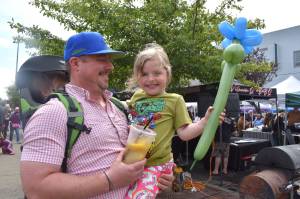 Matthew N. Wells / The Daily World
Ian VanDooren carries his son Thomas on his back and holds his daughter Emily. The VanDoorens had a ball at Aberdeen Summerfest. They enjoyed the balloons, the lemonde and the chicken Yakisoba. While they only tasted meat from a couple barbecue teams, they were happy. Thats what Aberdeen Summerfest is all about, to get friends and families, of all-ages, downtown.