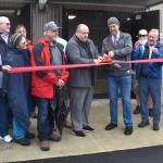 Matthew N. Wells / The Daily World
Hoquiam Mayor Ben Winkelman and Aberdeen Mayor Doug Orr cut the ceremonial ribbon for the opening of the Fry Creek Pump Station on a drizzly Tuesday afternoon. Along with Orr and Winkelman, many other people were in attendance, including city, county and state representatives, members of the Office of Chehalis Basin, representatives from Quigg Bros, Inc., and HDR Engineering Inc. Nick Bird, engineer for the city of Aberdeen, and others powered on two of the pumps.