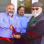 Westport city administrator Kevin Goodrich and hospital commissioner Michael Bruce cut the ceremonial ribbon opening a new clinic in Westport. (Michael S. Lockett / The Daily World)