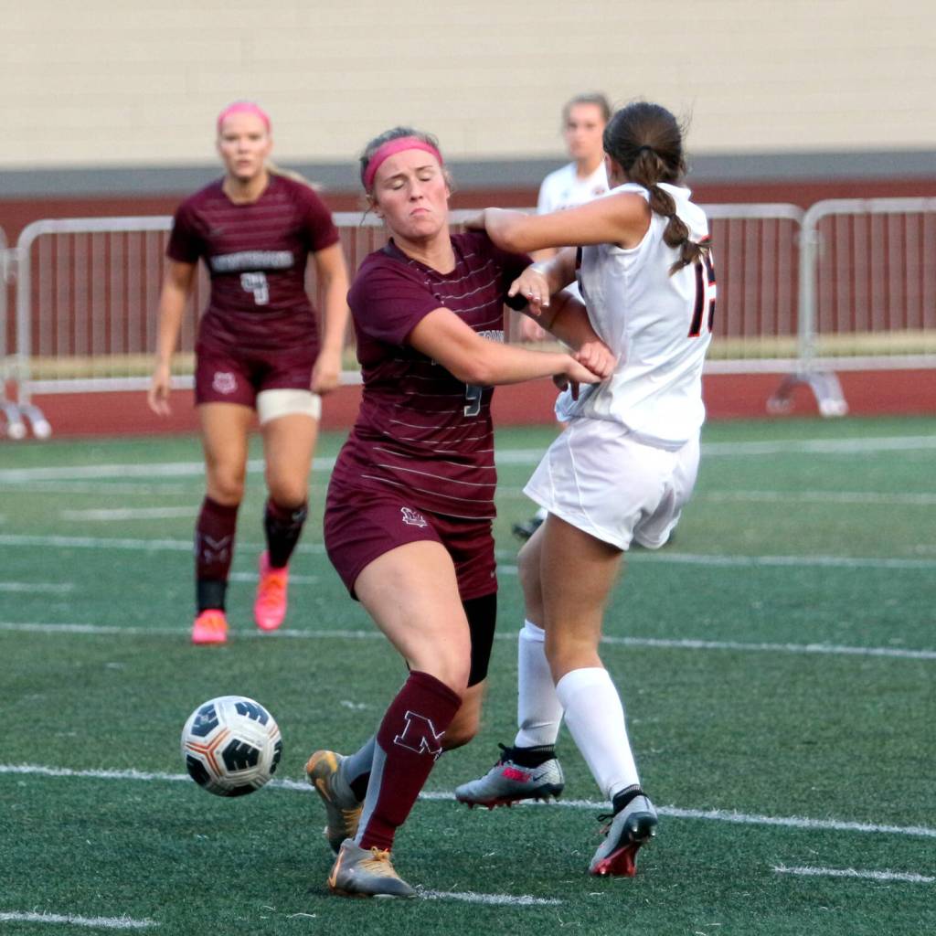 RYAN SPARKS | THE DAILY WORLD Montesanos Kennedy Campbell (left) collides with Napavines Ava Wilson during the Bulldogs 5-0 victory on Thursday at Montesano High School.