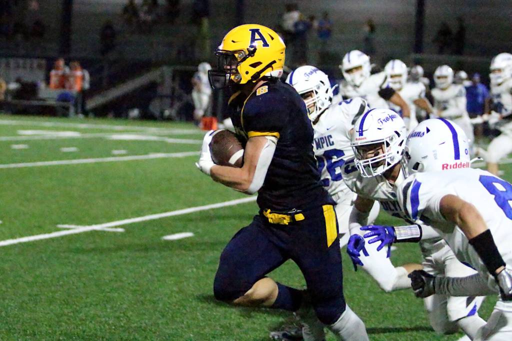 RYAN SPARKS | THE DAILY WORLD Aberdeen running back Micah Schroeder sprints away from the Olympic defense during a 20-6 loss on Friday at Stewart Field in Aberdeen.