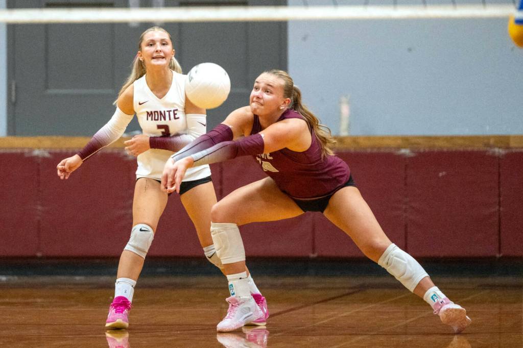 PHOTO BY FOREST WORGUM Montesano outside hitter Kalia Hatton (right) digs a ball while flanked by libero Bentley Warne during the Bulldogs 3-0 loss to Adna on Monday at Montesano High School.