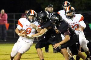 RYAN SPARKS | THE DAILY WORLD Rainier running back Dorien Cano (8) is tackled by Raymond-South Bends Isaac Schlueter (right) and Chris Banker during the Ravens 43-34 loss on Friday in Raymond.