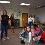 Matthew N. Wells / The Daily World
Jenny Floch, third from left, points out to McDermoth Elementary School students the artwork and how the library is laid out.