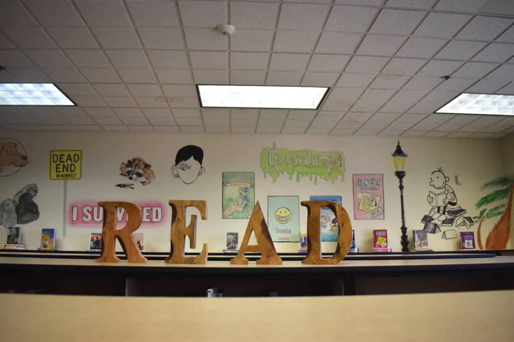 Ezri Carrolls Aberdeen High School senior project  artwork showing literary characters across multiple generations inside McDermoth Elementary School  lays out a simple message for her intended target audience: READ. The hope is the excitement the young students who toured the library with the new artwork keeps up for years to come. (Matthew N. Wells / The Daily World)