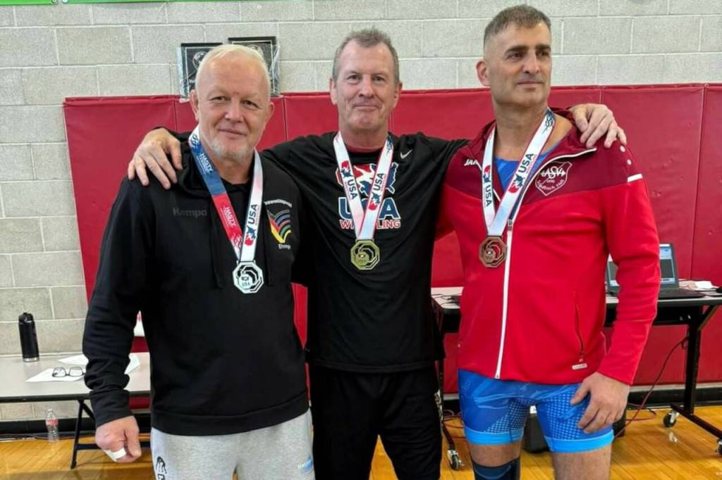 SUBMITTED PHOTO Elmas Kevin Pine (middle) is flanked by Germanys Eduard Hanzelmann (left) and Artak Ischchanjan as the three finished atop the podium of the 90kg Greco-Roman competition at the Masters 61-plus World Championships on Sept. 7-8 in Las Vegas, Nevada.