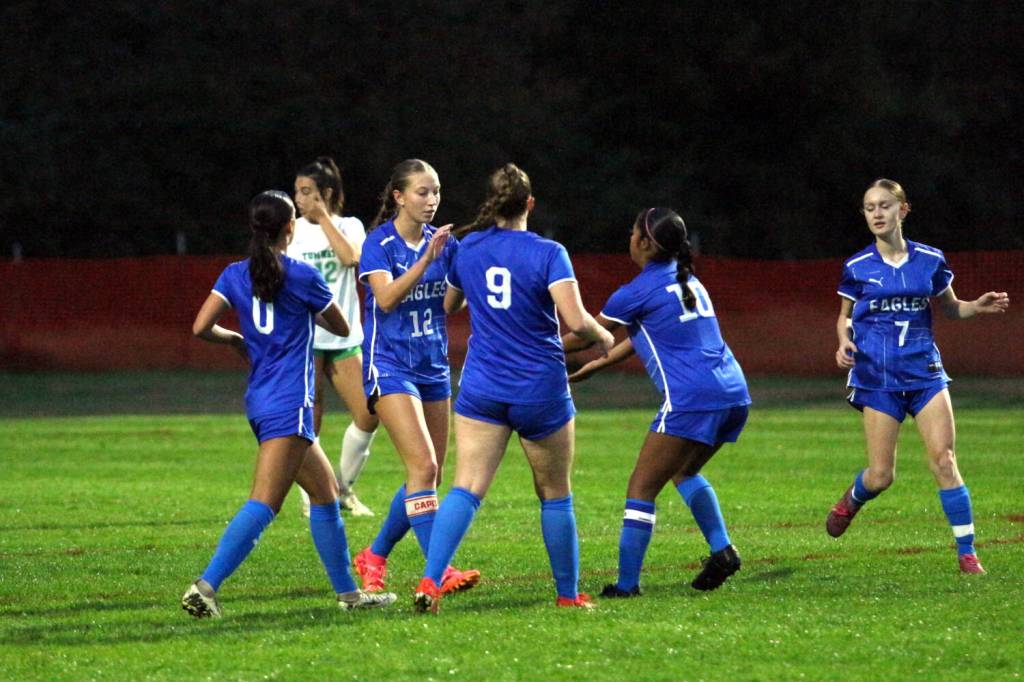 RYAN SPARKS | THE DAILY WORLD Elma senior forward Beta Valentine (12) is congratulated by her teammates after scoring on a penalty kick in the first half of Elmas 11-1 loss to Tumwater on Tuesday in Elma.