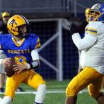 RYAN SPARKS | THE DAILY WORLD Aberdeen quarterback Mason Hill (left) prepares to throw while chased by Rochester defensive lineman Nicolas Mendiola during a 33-7 loss on Friday at Stewart Field in Aberdeen.
