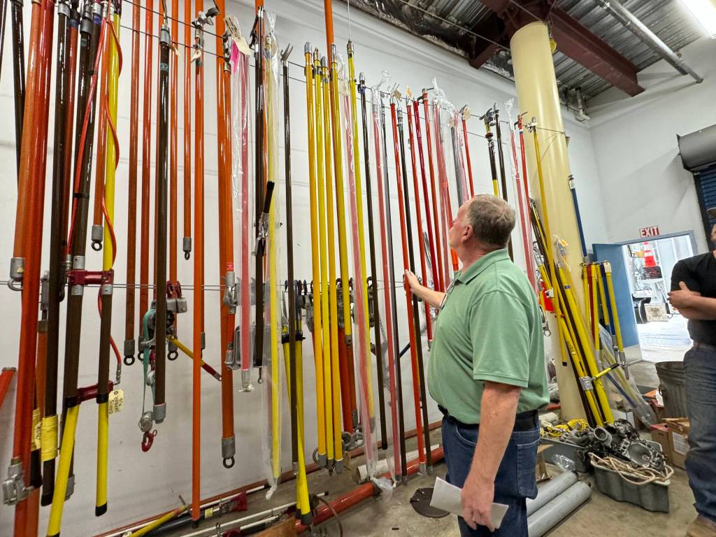 Michael S. Lockett / The Daily World
Grays Harbor PUD Operations Director Matt Rolow looks at the collection of hot sticks in the utilitys possession.