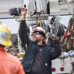 Michael S. Lockett / The Daily World
Line foreman Jason Johnson uses a plumb line to check a newly replaced pole against true.