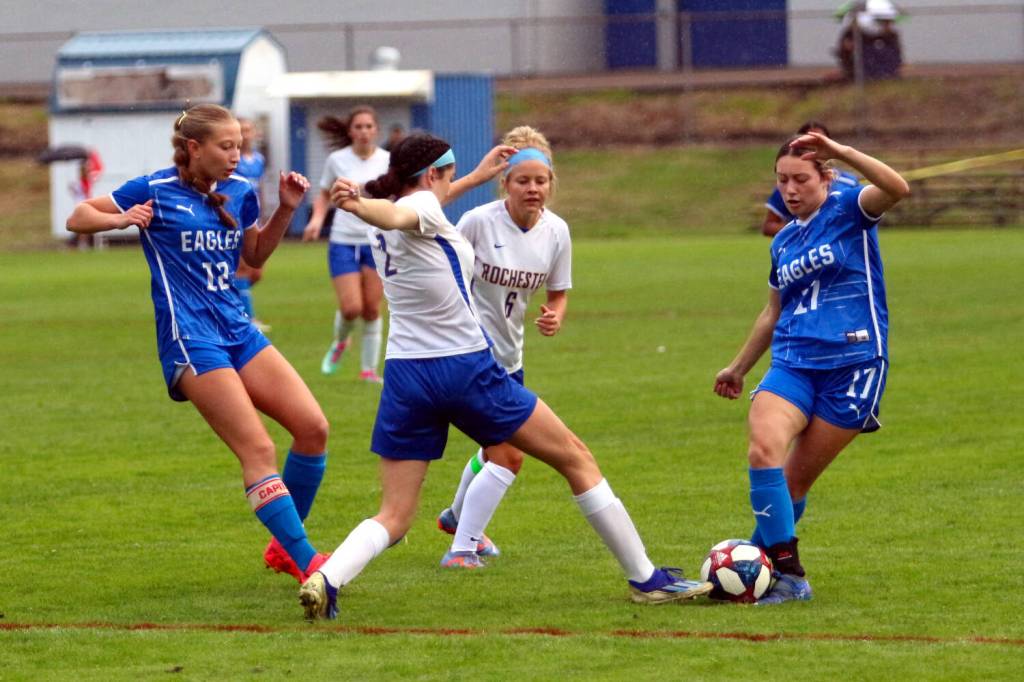 RYAN SPARKS | THE DAILY WORLD Elmas Aubree Simmons (17) and Beta Valentine (12) converge on the ball against Rochesters Kyanna Estrada (2) and Piper Quarnstrom during the Eagles 4-0 w