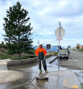 City of Aberdeen
Craig Yakovich, recreation supervisor for Aberdeen Parks and Recreation department, power-washes the sidewalk in front of Breaker, the art project that sits alongside Simpson Avenues bend.