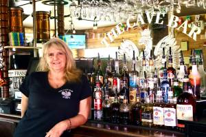 Michael S. Lockett / The Daily World
The Cave Bars owner Tracy Hatton poses for a photo in the newly reopened bar in Aberdeen.