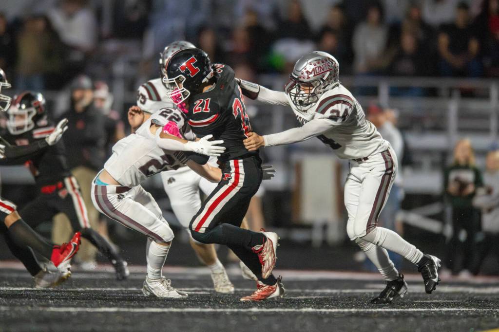 PHOTO BY FOREST WORGUM Montesano defenders Ashton McKinney and Kole Kjesbu tackles Teninos Jude Leitch during a 31-13 victory on Friday in Tenino.