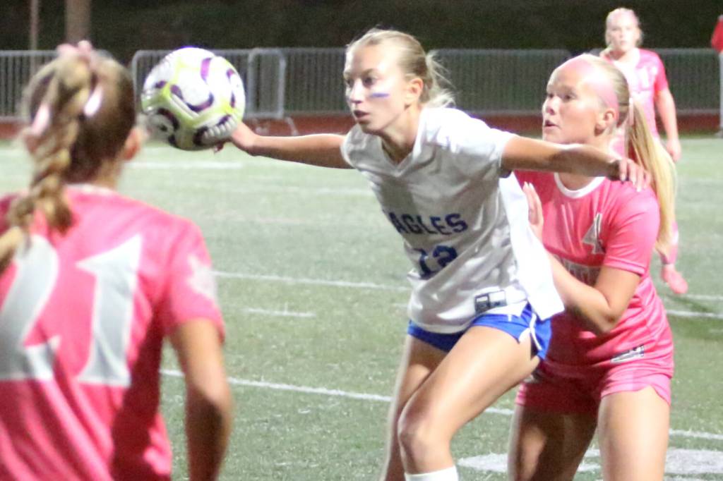 RYAN SPARKS | THE DAILY WORLD Elma senior forward Beta Valentine (12) makes a play on the ball while defended by Montesano midfielder Addi Kersker (right) during a 2-0 loss to Montesano on Thursday in Montesano.