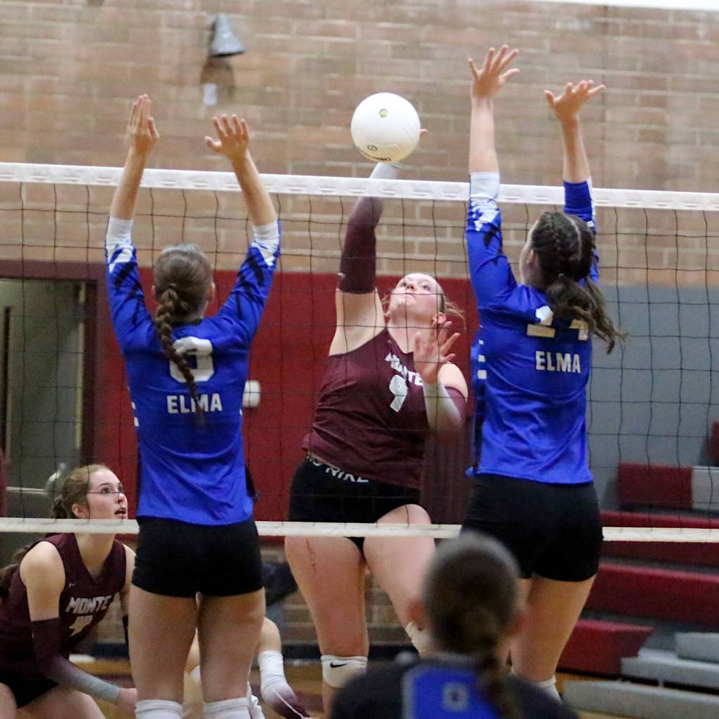 RYAN SPARKS | THE DAILY WORLD Montesanos Kylee Wisdom (9) puts up a shot between Elmas Jenessa Sackrider (3) and Emily Escoffon (14) during the Bulldogs straight-set win on Thursday in Montesano.