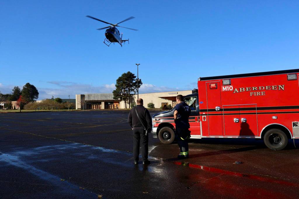 Michael S. Lockett / The Daily World
Chief Dave Golding, left, and an Aberdeen firefighter watch a medevac helicopter launch on Thursday.