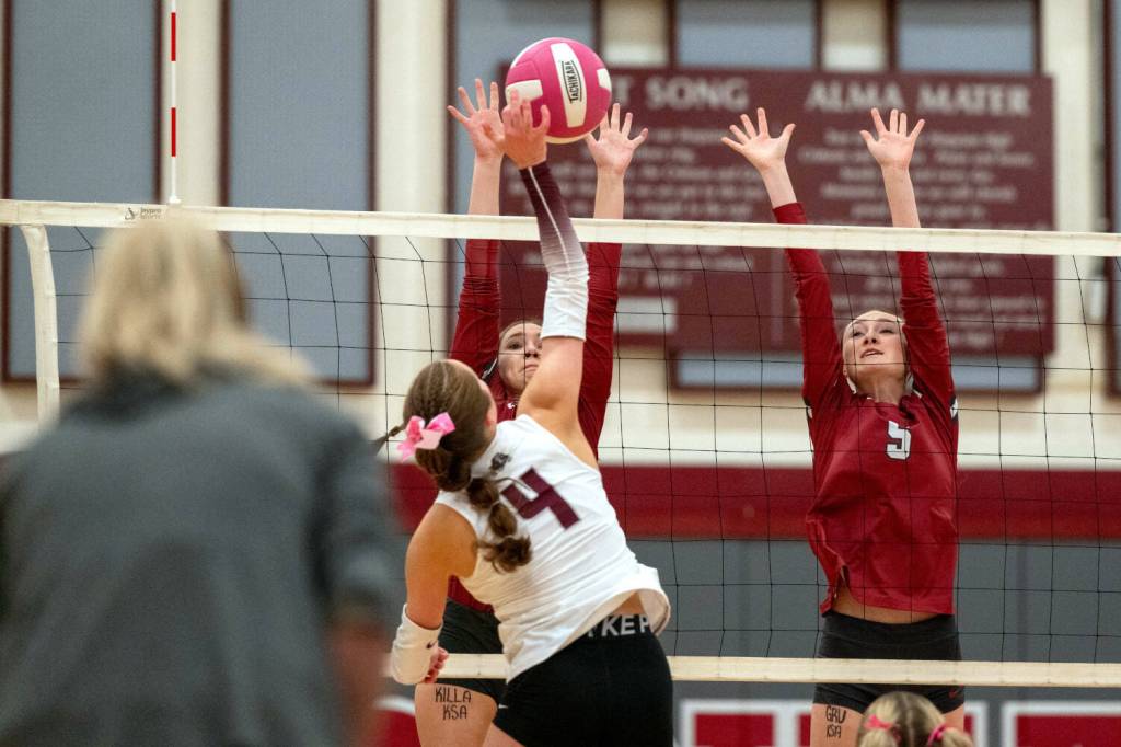 PHOTO BY FOREST WORGUM Montesanos Liv Robinson (4) attempts a kill against Hoquiams Hayden Brook-Andrew (5) and Katlyn Brodhead during the Bulldogs 3-0 win on Thursday at Hoquiam Square Garden.