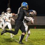 KODY CHRISTEN | THE CHRONICLE Rochesters Ethan Rodriguez stiff arms Montesanos Thomas Flink (20) en route to a touchdown during the Bulldogs 16-12 loss on Friday in Rochester.
