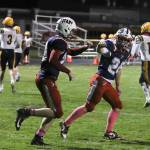 DYLAN WILHELM | THE CHRONICLE Pe Ell-Willapa Valley running back Cody Strozyk (left) fist bumps Lucas Lusk after a successful two-point conversion during a 34-6 win over Forks on Friday in Pe Ell.