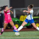 PHOTO BY ASHER HOLCOMB Montesanos Jaelyn Butterfield (left) competes for possession with Rochesters Chloe Hess during the Bulldogs 4-0 win on Tuesday at Jack Rottle Field in Montesano.