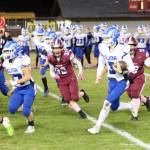 RYAN SPARKS | THE DAILY WORLD Elma quarterback Isaac McGaffey (3) looks for running room during a 36-14 win over Hoquiam on Friday at Olympic Stadium in Hoquiam.