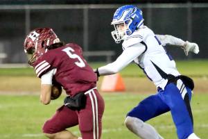RYAN SPARKS | THE DAILY WORLD Hoquiams Kingston Case (5) races away from Elmas Isaac McGaffey during the Eagles 36-14 win on Friday at Olympic Stadium in Hoquiam.