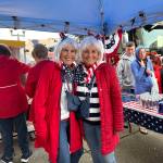 Bette Worth, left, and Bobbi McCracken were having a blast and working hard with other volunteers at the candy, pop and popcorn station for Downtown Aberdeen Association. (Matthew N. Wells / The Daily World)