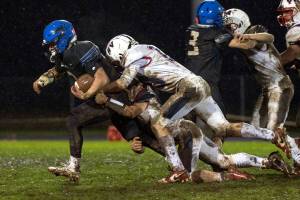KODY CHRISTEN | THE CHRONICLE Adnas Luke Mohney (left) is tackled by Pe Ell-Willapa Valleys Cody Mican (10) during the Titans 14-0 loss on Thursday in Adna.