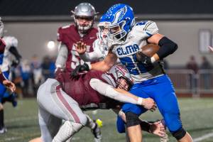 PHOTO BY FOREST WORGUM Montesano linebacker Felix Romero (left) tackles Elma running back Bo Muller during the Bulldogs 45-0 win on Friday in Montesano.