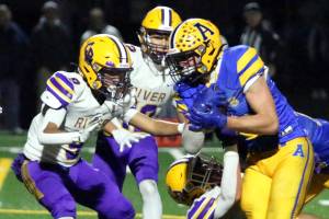 RYAN SPARKS | THE DAILY WORLD Aberdeen running back Micah Schroeder (right) carries the ball against Columbia River defensive back Aedan Pena during the Bobcats 7-6 loss in a 2A State play-in matchup on Tuesday at Stewart Field in Aberdeen.