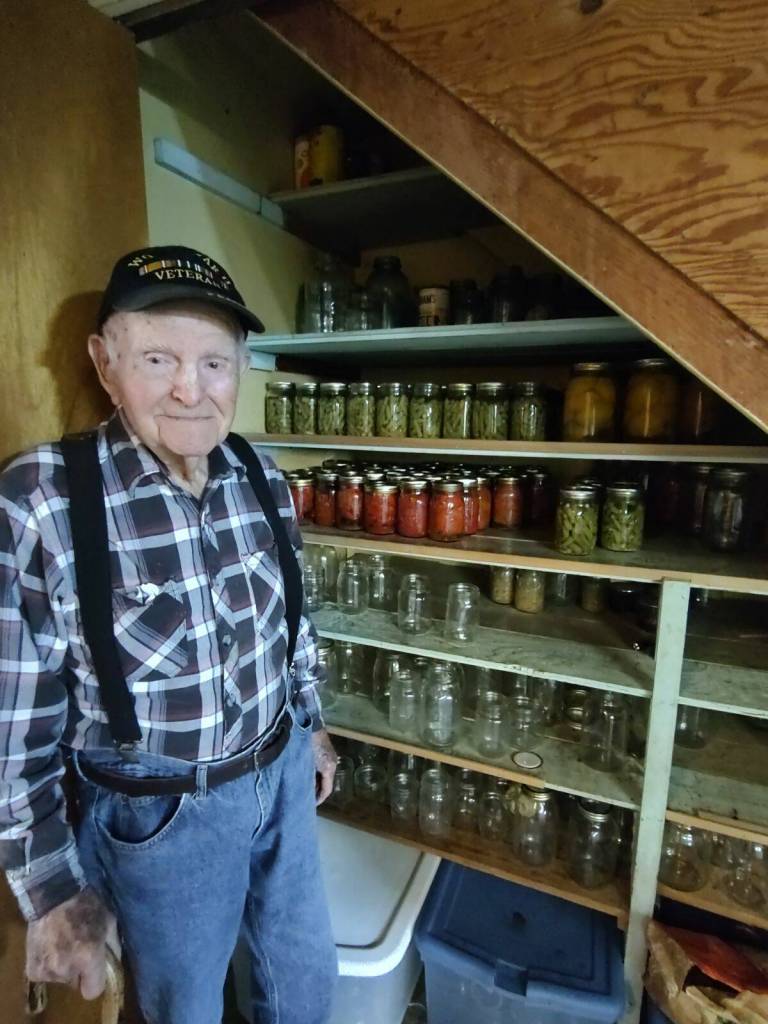 Howard takes his garden bounty and puts up his canned goods, all done by him.